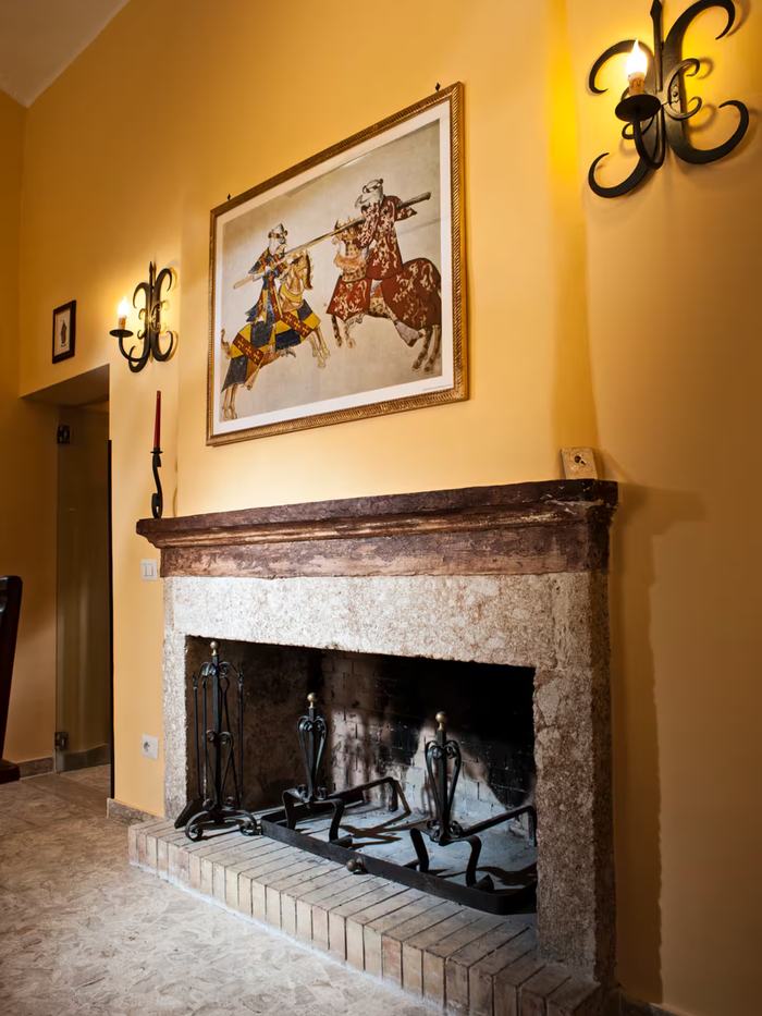 The fireplace with painting and andirons